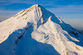 Strong shadow tracing the crags of Mount Hood's summit ridge under a deep blue sky