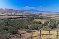Cypresses along a track seen from a vantage above the Val d'Orcia, ridge behind ridge to Monte Amiata